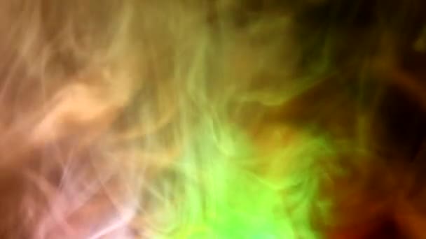 Curly creeping puffs of smoke on a dark background, illuminated by light with different colors. — Stock Video