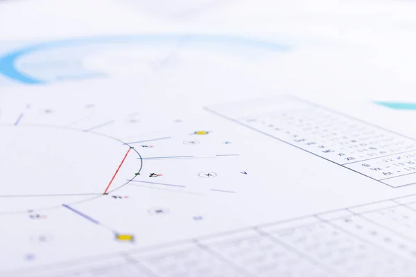 The desktop of an astrologer. The magical mysterious atmosphere of the working environment of the predictor of the future. Printouts of astrological charts and tables scattered across the table.