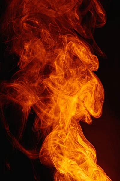 Orange smoke on a dark background. Intricate swirls of colored smoke. — Stock Photo, Image