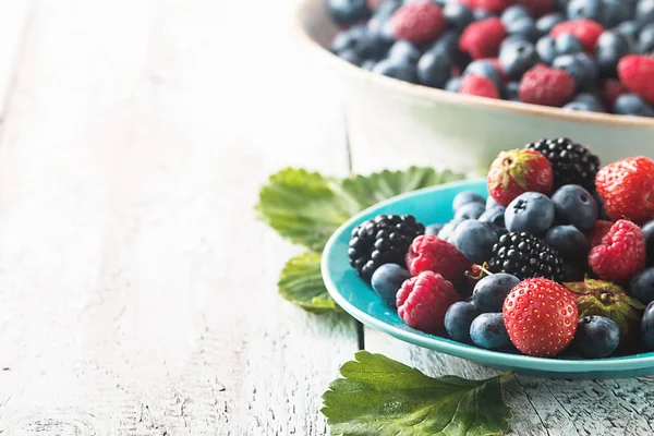 Different berries in bowl. — Stock Photo, Image