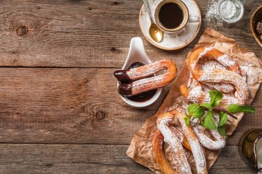churros, coffee and hot chocolate on wooden table, top view clipart