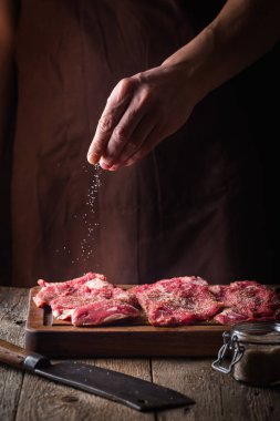 Man cooking meat steaks clipart