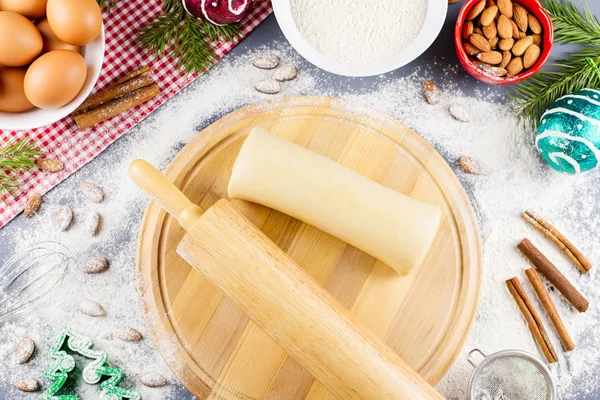 Christmas cookie ingredients, rolling pin and cookie cutters. Christmas cooking concept. Top view