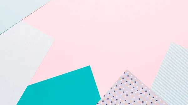 Paper geometric background in pink and mint colors. Geometric shapes, minimalisctic backdrop with colored paper, frame, top view, copy space