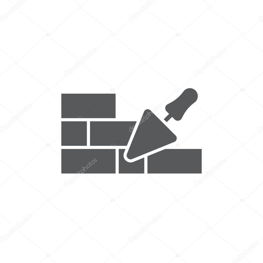 Trowel and brick wall vector icon symbol isolated on white background