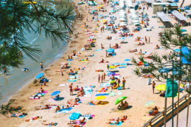 Panoramic view of a crowded beach in unfocus. Summer or vacation concept. clipart