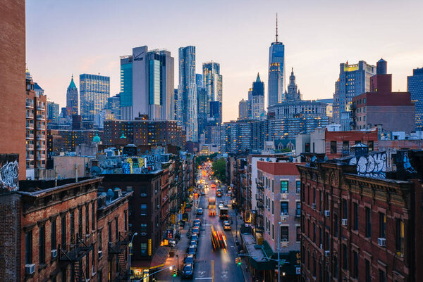 View of Madison Street and Lower Manhattan at sunset from the Manhattan Bridge in New York City