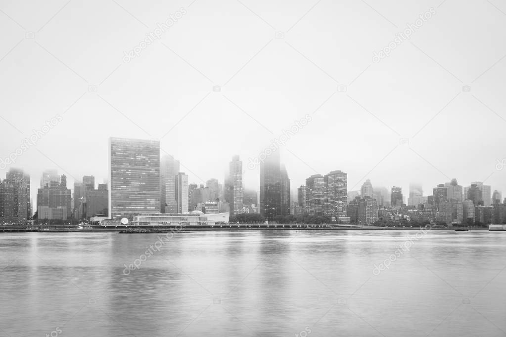 Foggy view of the Manhattan skyline from Gantry Plaza State Park, in Long Island City, Queens, New York City.