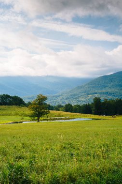View of a pond and mountains in the rural Potomac Highlands of West Virginia. clipart
