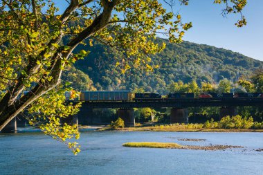 A train crossing the Potomac River in Harpers Ferry, West Virginia. clipart
