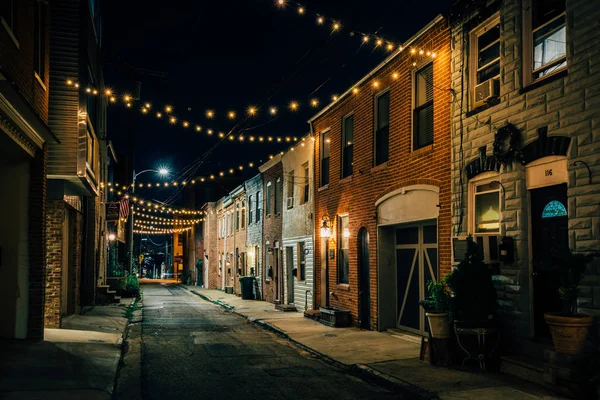 String lights over Chapel Street at night in Butchers Hill, Baltimore, Maryland