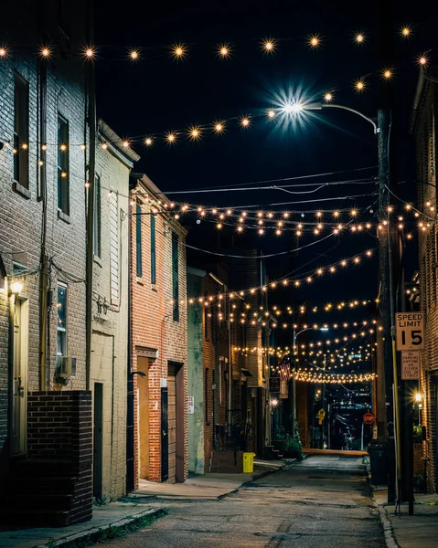 String lights over Chapel Street at night in Butchers Hill, Baltimore, Maryland