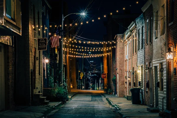 String lights over Chapel Street at night in Butchers Hill, Baltimore, Maryland