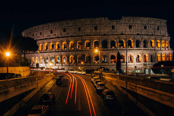 Via degli Annibaldi and the Colosseum at night, in Rome, Italy.