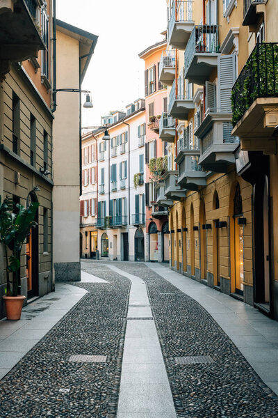 A cobblestone street and colorful buildings in Brera, Milan
