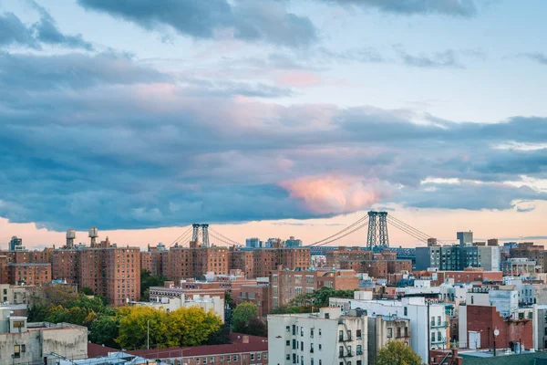 View of the Williamsburg Bridge and East Village at sunset, in M