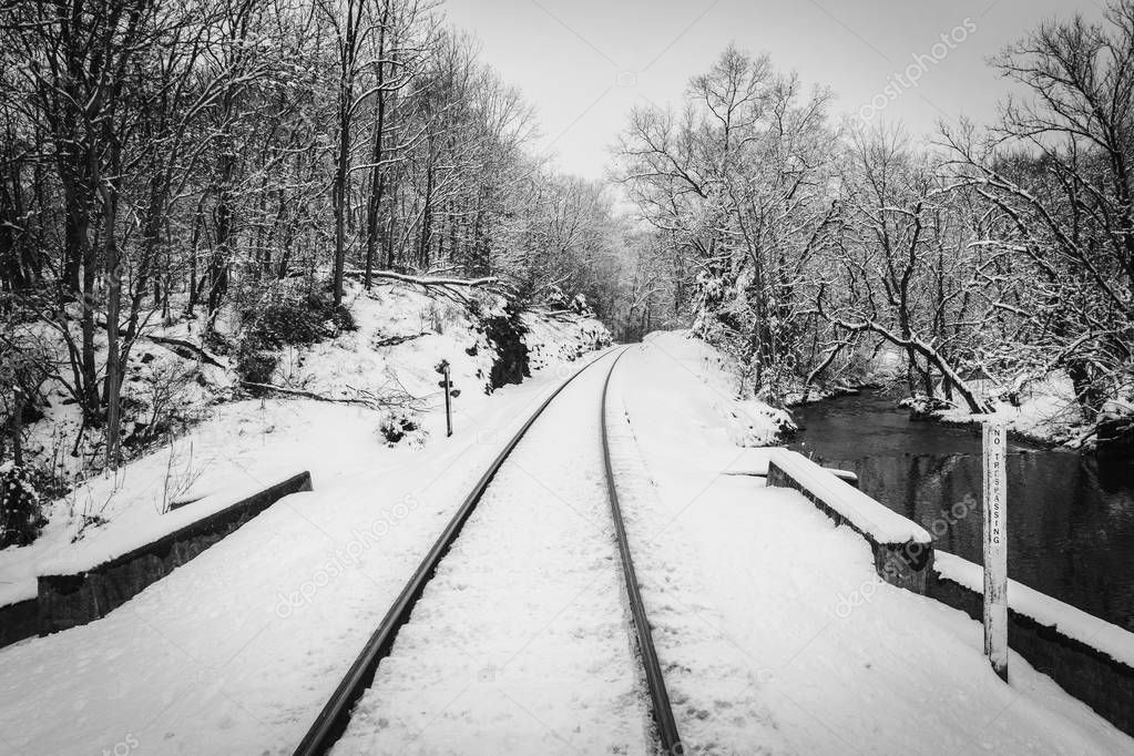 A snow covered railroad track and creek in rural Carroll County, Maryland.