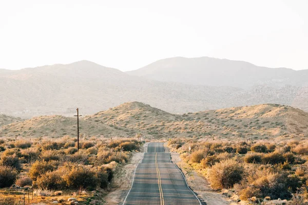 En kuperet vej i ørkenen, i Pioneertown, Californien - Stock-foto