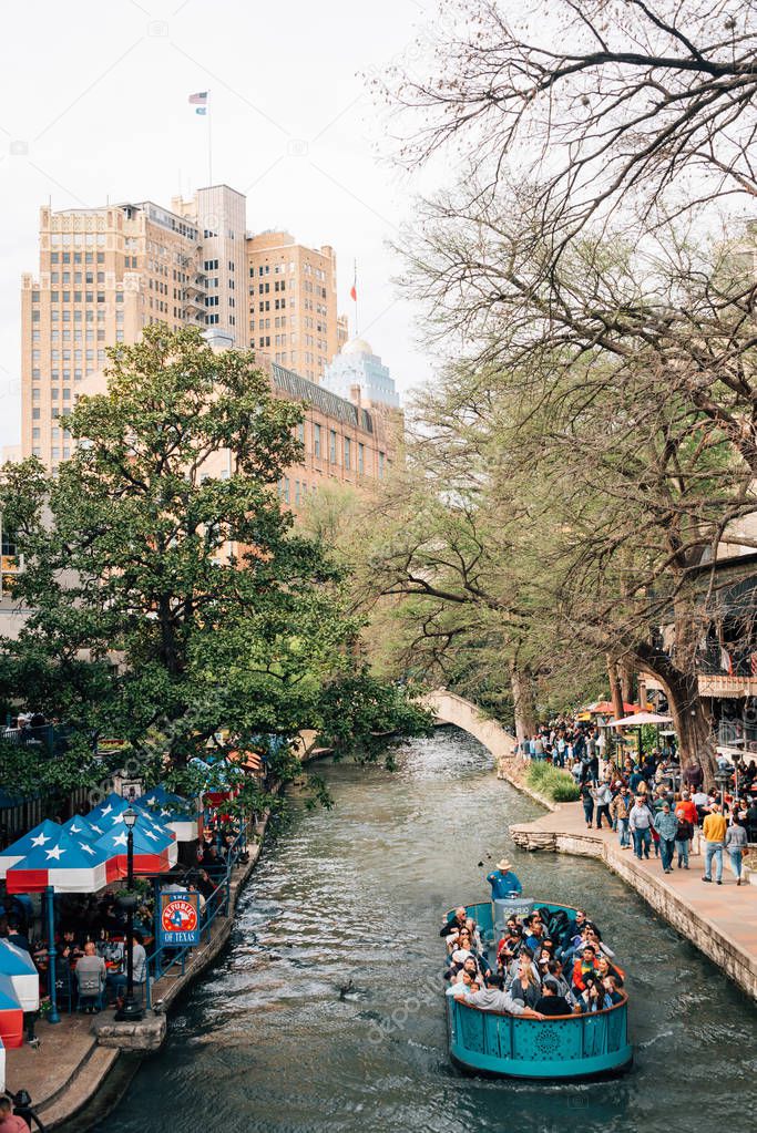 A boat and The Riverwalk in San Antonio, Texas