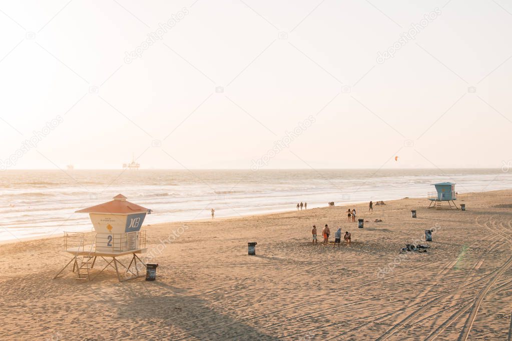 View of lifeguard stands on the beach at sunset, in Huntington B