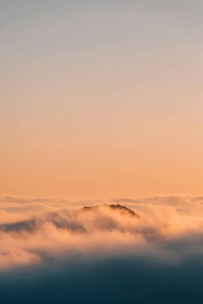 View of marine layer low clouds over Los Angeles at sunset, from