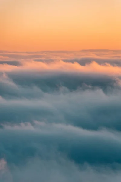 View of marine layer low clouds over Los Angeles at sunset, from