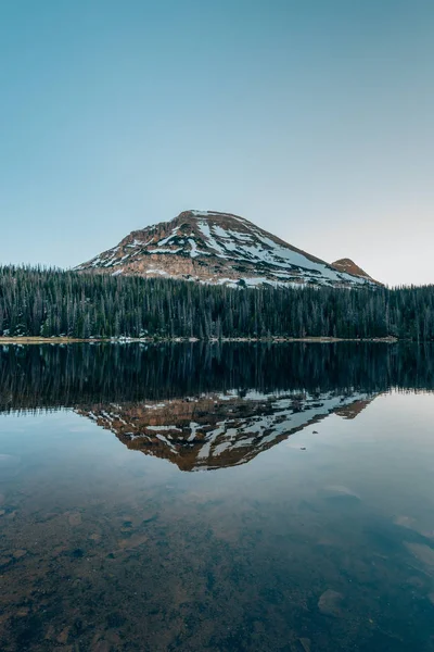 Snowy mountains reflecting in Mirror Lake, in the Uinta Mountain