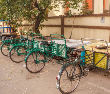 Yeşil renkli üç tekerlekli bisiklet görünümü yolda bir kenara park, Chennai, Hindistan