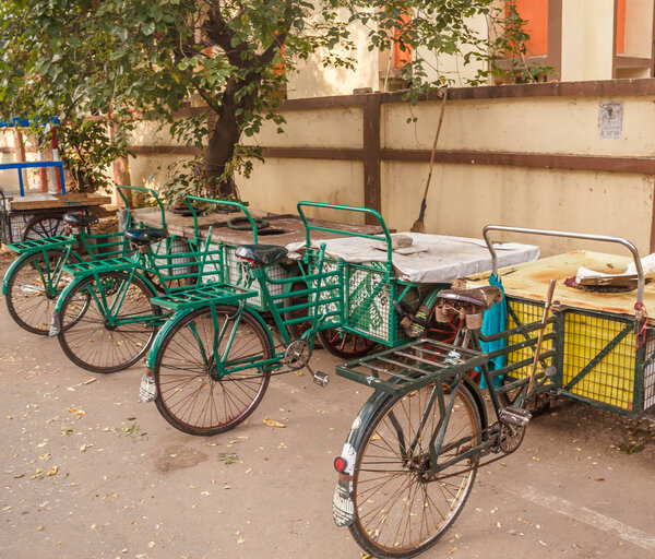 View of green colored tricycle parked aside on the road, Chennai, India
