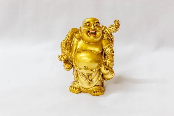 Laughing Buddha painted in gold color with white backdrop