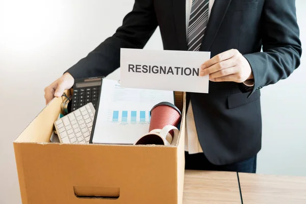 Businessperson carrying packing personal company on brown cardbo