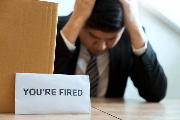 Businessperson carrying packing personal company on brown cardbo