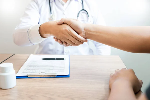 Medicine healthcare and trust concept, doctor shaking hands with