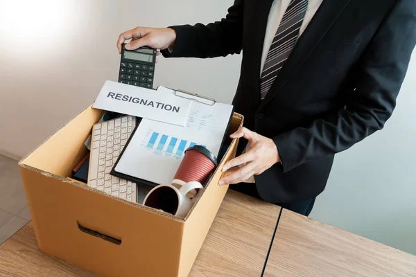 Businessperson carrying packing personal company on brown cardbo