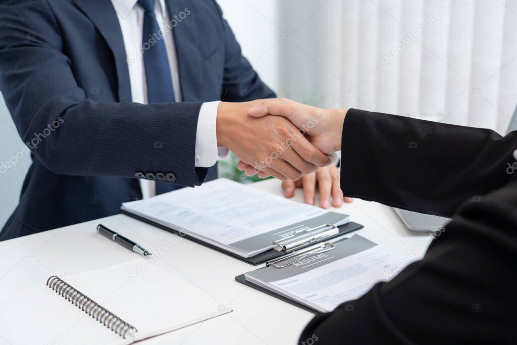 two business people shaking hands of Candidate asian businesswoman after successful negotiations or interview, career and placement concept 