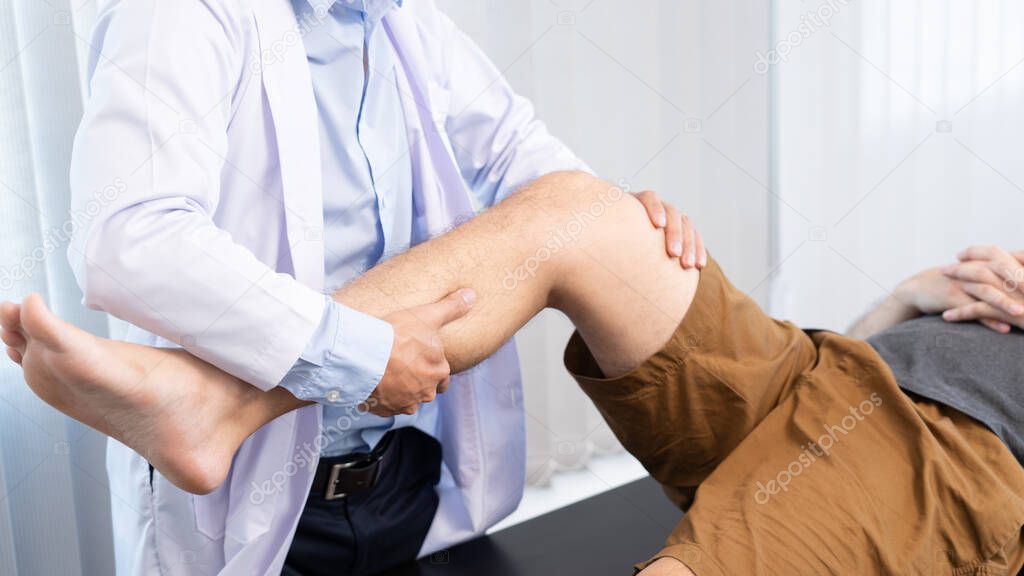 physiotherapist doctor rehabilitation consulting physiotherapy giving exercising knee treatment with patient in physio clinic or hospital