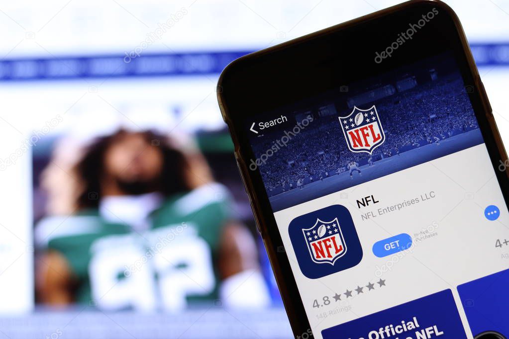Mobile phone with NFL logo on screen close up with website on laptop. Blurred background with NFL football news. Los Angeles, California, USA - 27 October 2019, Illustrative Editorial