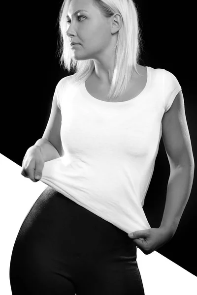 Black and white split portrait of woman standing in studio — Stock Photo, Image