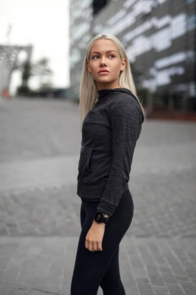 Urban scandinavian woman in workout outfit standing in the city — Stock Photo, Image