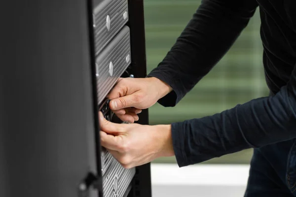 Técnico masculino ajustando o armário de disco em SAN no Datacenter — Fotografia de Stock