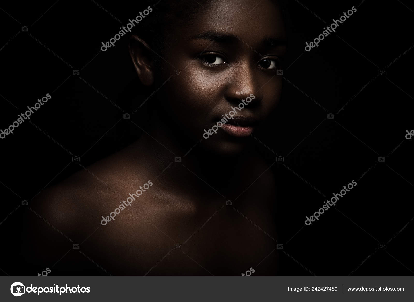 Natural dark portrait of beautiful african woman on black bakground ...