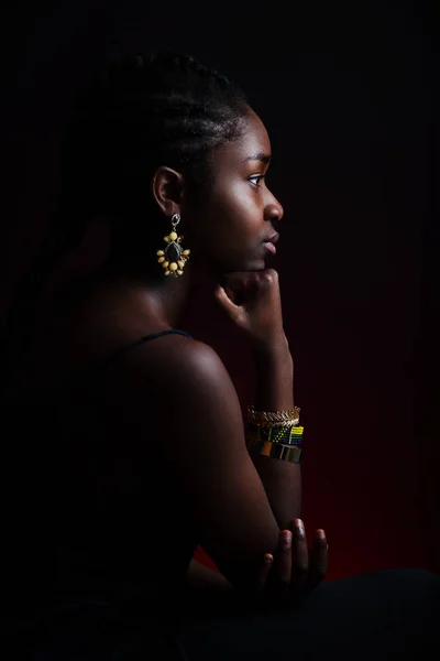 Colorful and dark side view portrait of native african woman