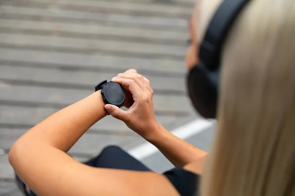 Female runner setting up the fitness smart watch for running — Stock Photo, Image