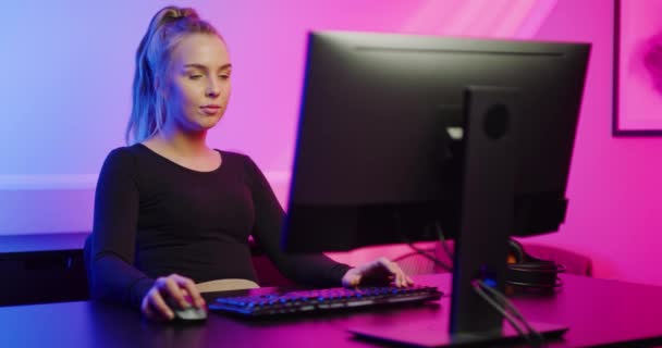 Bela menina Gamer E-sport com fone de ouvido jogando jogo de vídeo on-line no PC — Vídeo de Stock