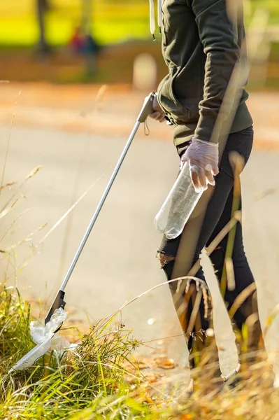 Hombre voluntario recogiendo basura plástica de la hierba — Foto de Stock