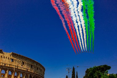 Rome, Italy, 02 / June / 2019. For the feast of the republic, the tricolor arrows representing the Italian flag fly over the Colosseum and the Imperial Forums. clipart
