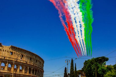 Rome, Italy, 02 / June / 2019. For the feast of the republic, the tricolor arrows representing the Italian flag fly over the Colosseum and the Imperial Forums. clipart