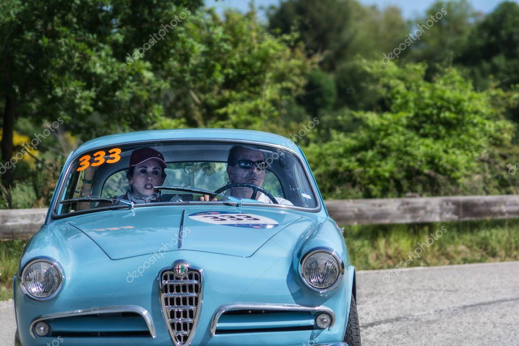 PESARO COLLE SAN BARTOLO , ITALY - MAY 17 - 2018 : ALFA ROMEO GIULIETTA SPRINT BERTONE PIERO PELU on an old racing car in rally Mille Miglia 2018 the famous italian historical race (1927-1957)