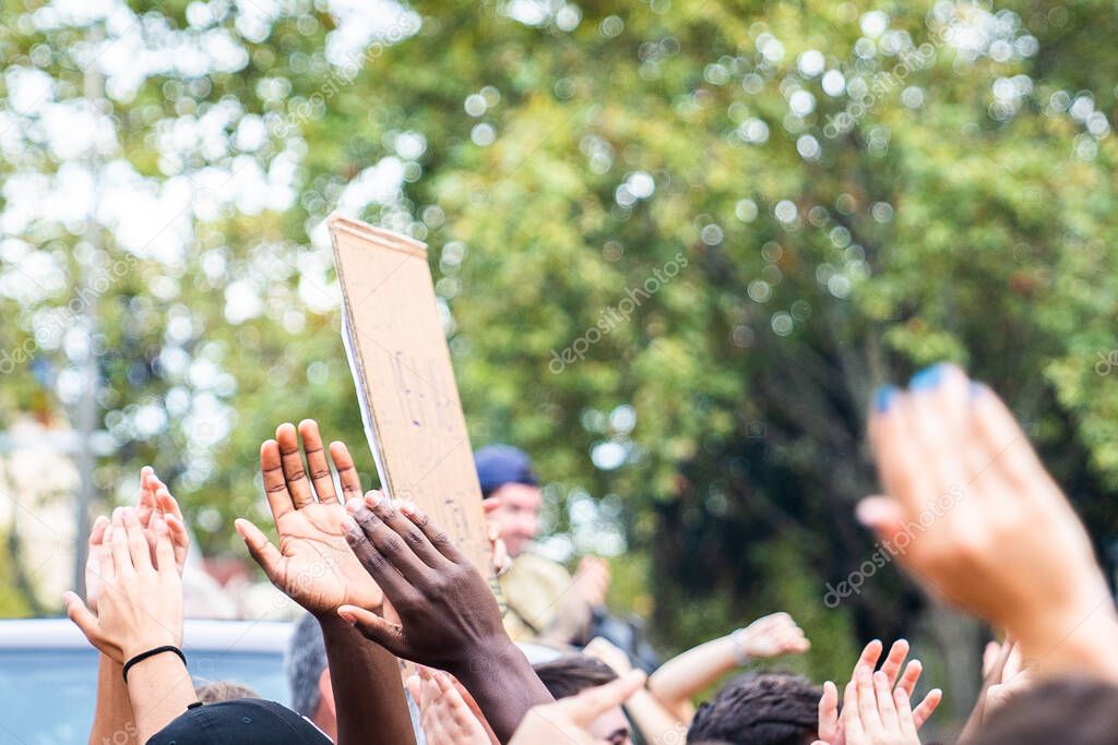 Multicultural hands raised in the air asking for freedom. Stop racism.