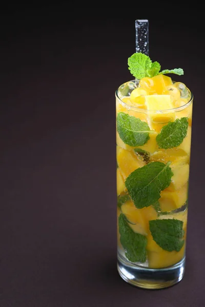 Mango and passion fruit cocktail with fresh mint, drink for catering of a celebration.